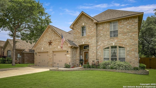 view of front of home with brick siding, a garage, driveway, and a front yard