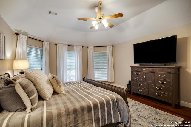 bedroom with baseboards, ceiling fan, dark wood-style flooring, and visible vents
