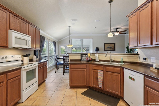 kitchen with dark countertops, white appliances, a sink, and crown molding