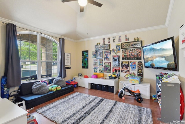 rec room with vaulted ceiling, wood finished floors, ceiling fan, and crown molding