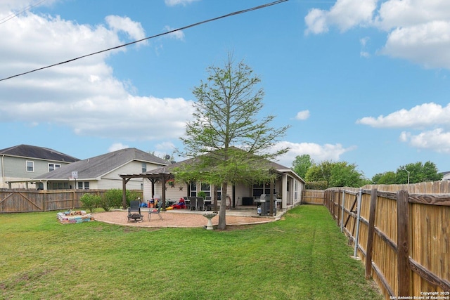 rear view of property with a yard, a pergola, a patio area, and a fenced backyard