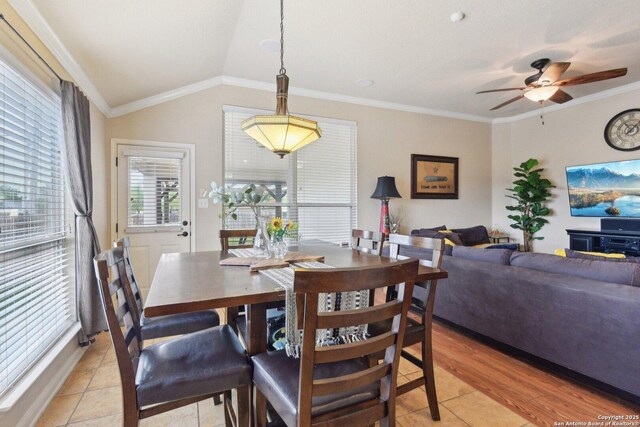 dining room with vaulted ceiling, ornamental molding, and ceiling fan