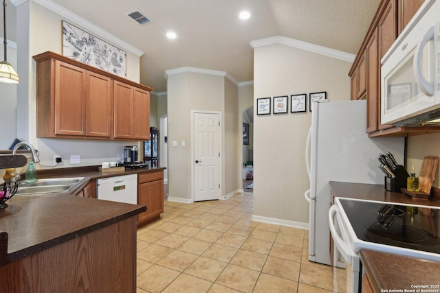 kitchen with crown molding, dark countertops, a sink, white appliances, and visible vents