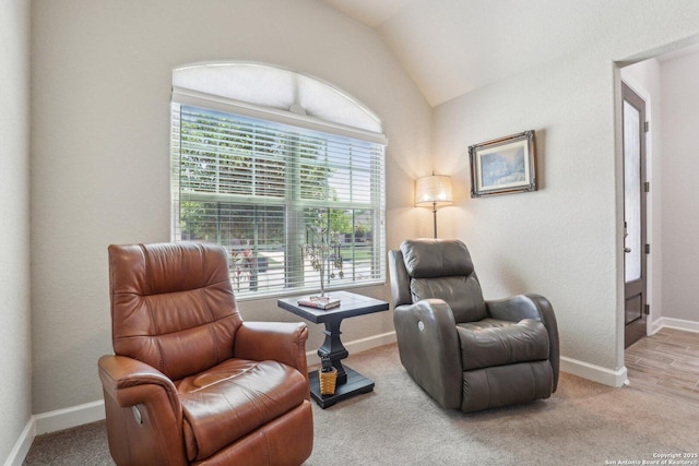 sitting room featuring lofted ceiling, carpet flooring, and baseboards