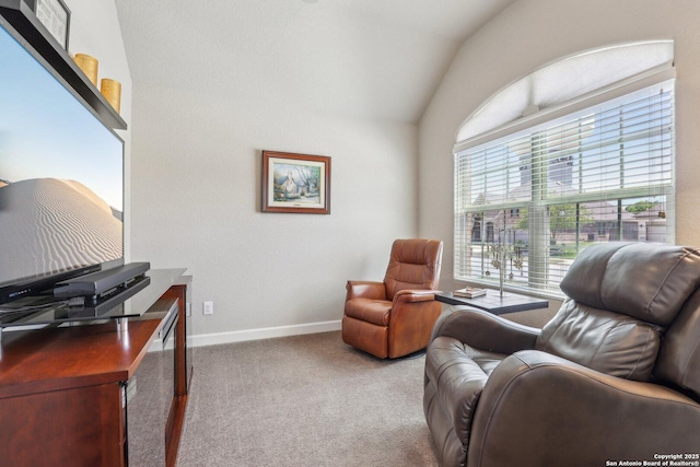 sitting room with vaulted ceiling, carpet, and baseboards