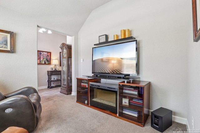 carpeted living room with lofted ceiling and baseboards