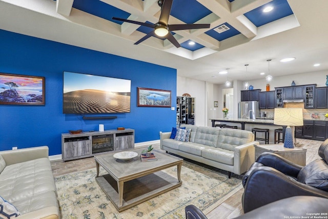 living room with recessed lighting, coffered ceiling, beamed ceiling, and light wood-style flooring