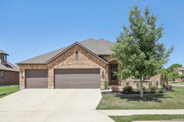 view of front of property featuring brick siding, roof with shingles, and concrete driveway