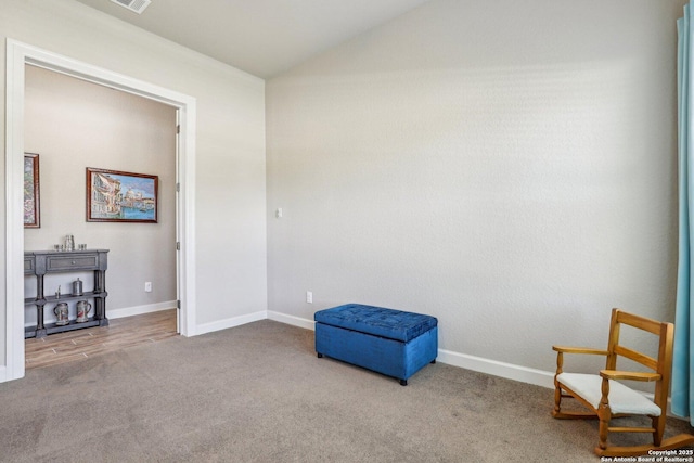unfurnished room with vaulted ceiling, carpet, a wood stove, and baseboards