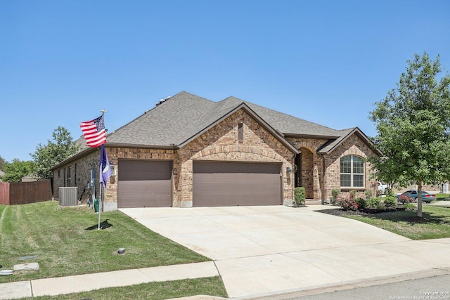 view of front of property featuring cooling unit, concrete driveway, brick siding, an attached garage, and a front yard