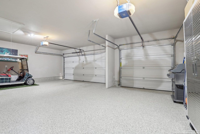 garage with baseboards and a garage door opener