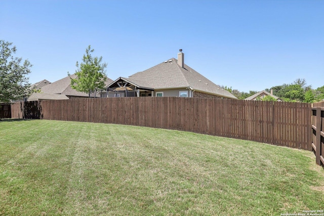 view of yard with a fenced backyard