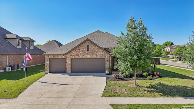 view of front of property with driveway, a garage, brick siding, a shingled roof, and a front yard