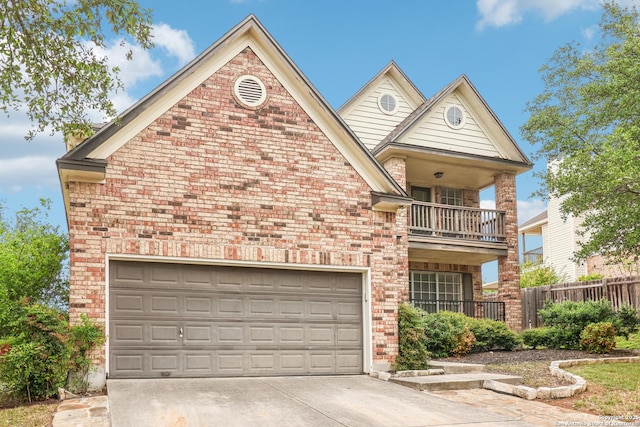 24915 Flying Arrow, San Antonio, TX 78258 - view of front of house with concrete driveway, fence, a balcony, and brick siding