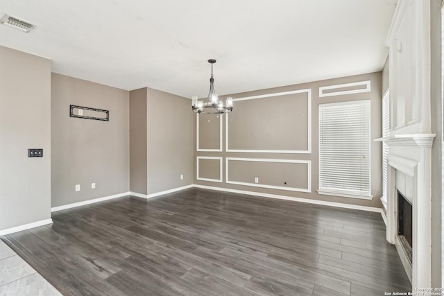 24915 Flying Arrow, San Antonio, TX 78258 - unfurnished dining area featuring visible vents, dark wood-style floors, baseboards, and a notable chandelier