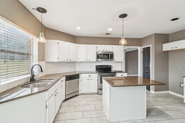 24915 Flying Arrow, San Antonio, TX 78258 - kitchen with visible vents, dark stone countertops, stainless steel appliances, and a sink