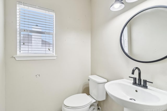 24915 Flying Arrow, San Antonio, TX 78258 - half bath with a healthy amount of sunlight, toilet, and a sink