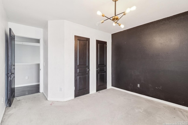 24915 Flying Arrow, San Antonio, TX 78258 - unfurnished bedroom with baseboards, carpet floors, and a notable chandelier
