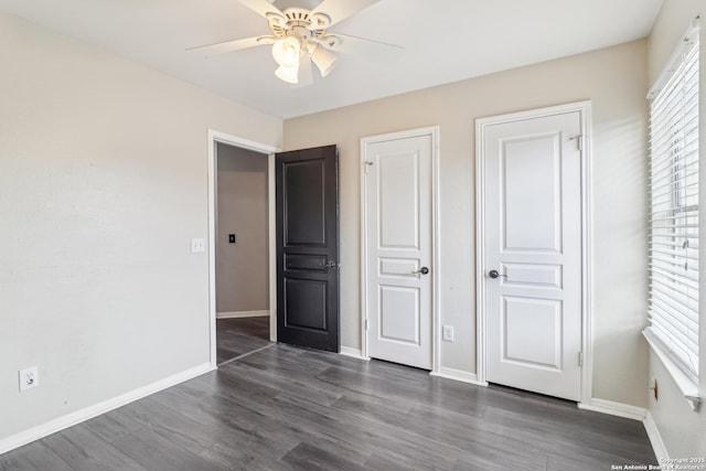24915 Flying Arrow, San Antonio, TX 78258 - unfurnished bedroom with a ceiling fan, baseboards, and dark wood-style flooring