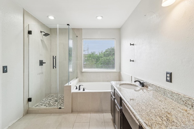 24915 Flying Arrow, San Antonio, TX 78258 - bathroom with a bath, a shower stall, tile patterned floors, and vanity