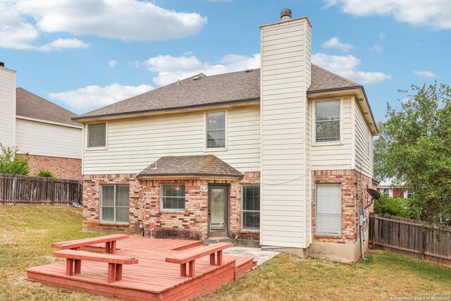 24915 Flying Arrow, San Antonio, TX 78258 - rear view of property with roof with shingles, a fenced backyard, brick siding, a lawn, and a deck