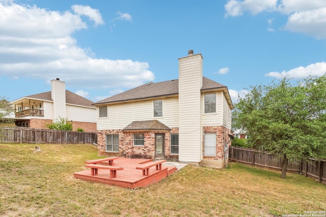 24915 Flying Arrow, San Antonio, TX 78258 - back of property featuring a shingled roof, a fenced backyard, a yard, brick siding, and a deck