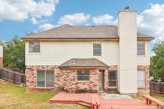 24915 Flying Arrow, San Antonio, TX 78258 - rear view of property featuring roof with shingles, fence, brick siding, a wooden deck, and a lawn
