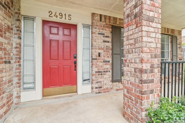 24915 Flying Arrow, San Antonio, TX 78258 - doorway to property featuring brick siding and covered porch
