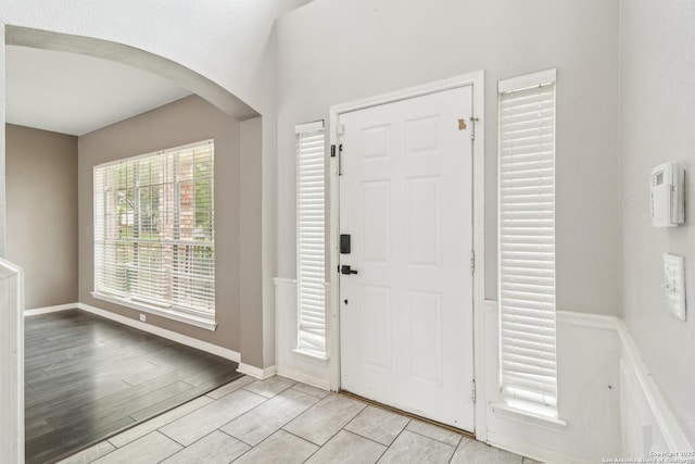 24915 Flying Arrow, San Antonio, TX 78258 - foyer with baseboards, arched walkways, and light wood-style floors