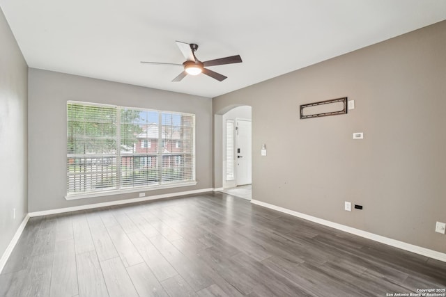 24915 Flying Arrow, San Antonio, TX 78258 - interior space featuring a ceiling fan, baseboards, arched walkways, and dark wood finished floors