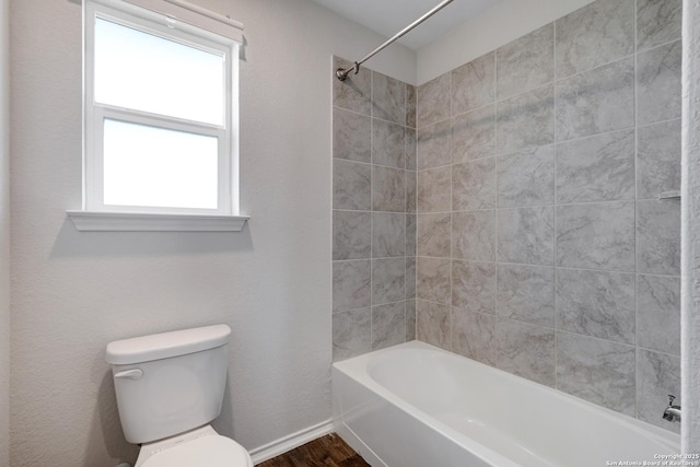 6551 Legato, San Antonio, TX 78252 - full bathroom featuring baseboards, shower / bathtub combination, wood finished floors, and toilet