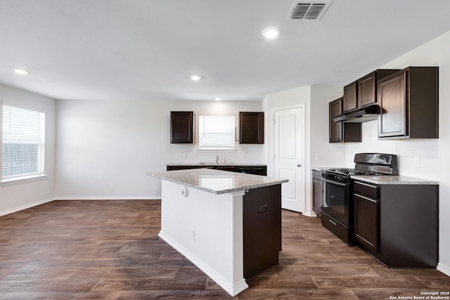 6551 Legato, San Antonio, TX 78252 - kitchen featuring dark brown cabinets, visible vents, black gas range oven, and under cabinet range hood
