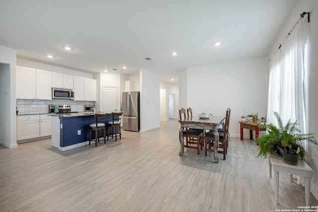 209 Wolf Crst, Seguin, TX 78155 - dining space featuring light wood-type flooring and recessed lighting