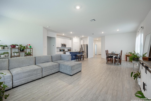 209 Wolf Crst, Seguin, TX 78155 - living room with light wood finished floors and recessed lighting