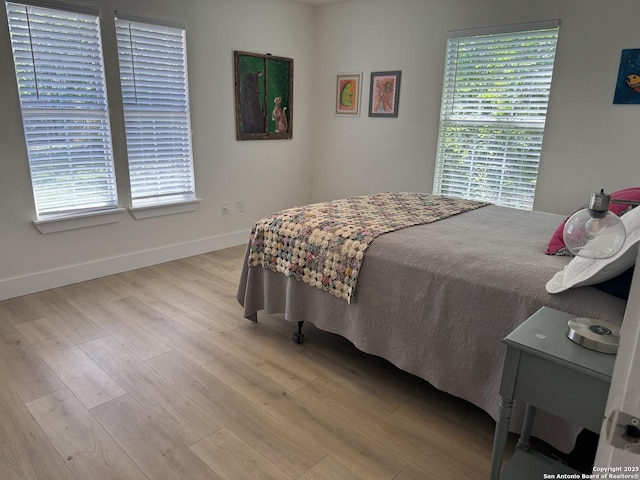 bedroom featuring light wood-type flooring and baseboards