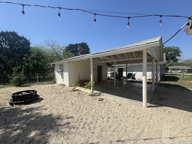 exterior space featuring gravel driveway, fence, and an attached carport