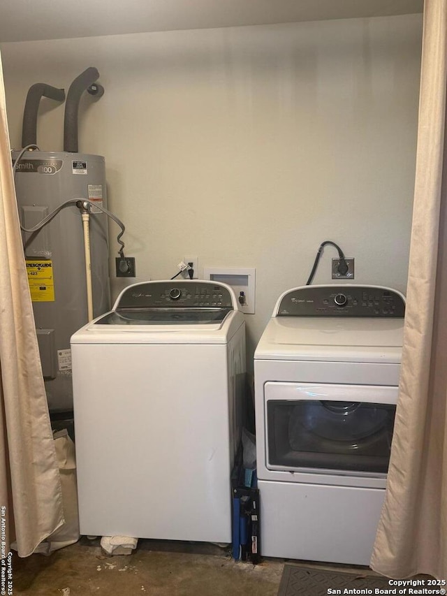 laundry area featuring washer and dryer, electric water heater, and laundry area