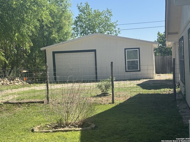 detached garage featuring fence
