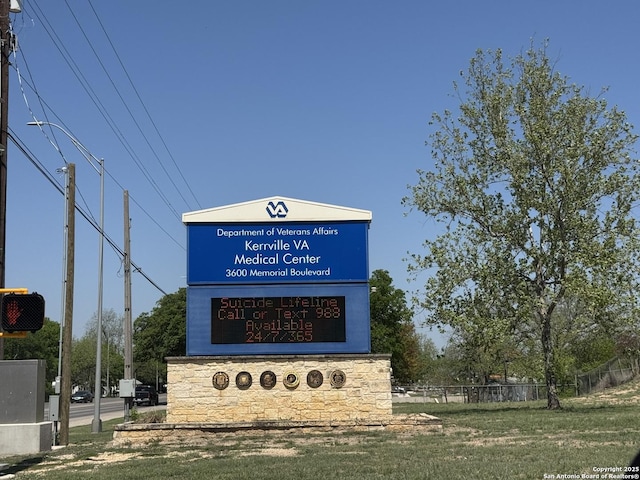 community / neighborhood sign with fence