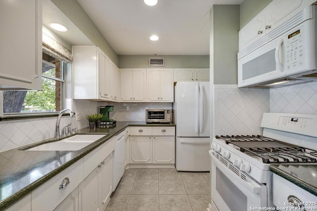 1815 Edgehill Dr, San Antonio, TX 78209 - kitchen with backsplash, visible vents, a sink, white appliances, and white cabinetry