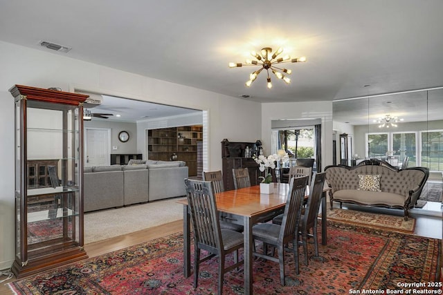 1815 Edgehill Dr, San Antonio, TX 78209 - dining room featuring wood finished floors, visible vents, and a notable chandelier