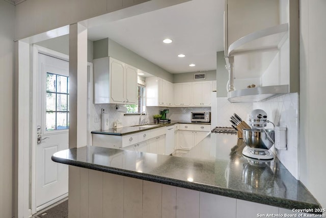 1815 Edgehill Dr, San Antonio, TX 78209 - kitchen with a toaster, open shelves, visible vents, a sink, and decorative backsplash