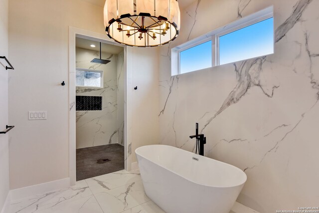 full bath with marble finish floor, a soaking tub, a chandelier, and a marble finish shower