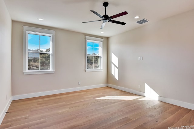 unfurnished room with baseboards, visible vents, light wood-style floors, and a healthy amount of sunlight