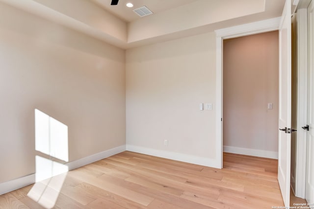 spare room with baseboards, light wood finished floors, visible vents, and recessed lighting