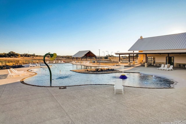 pool featuring a gazebo, fence, and a patio area