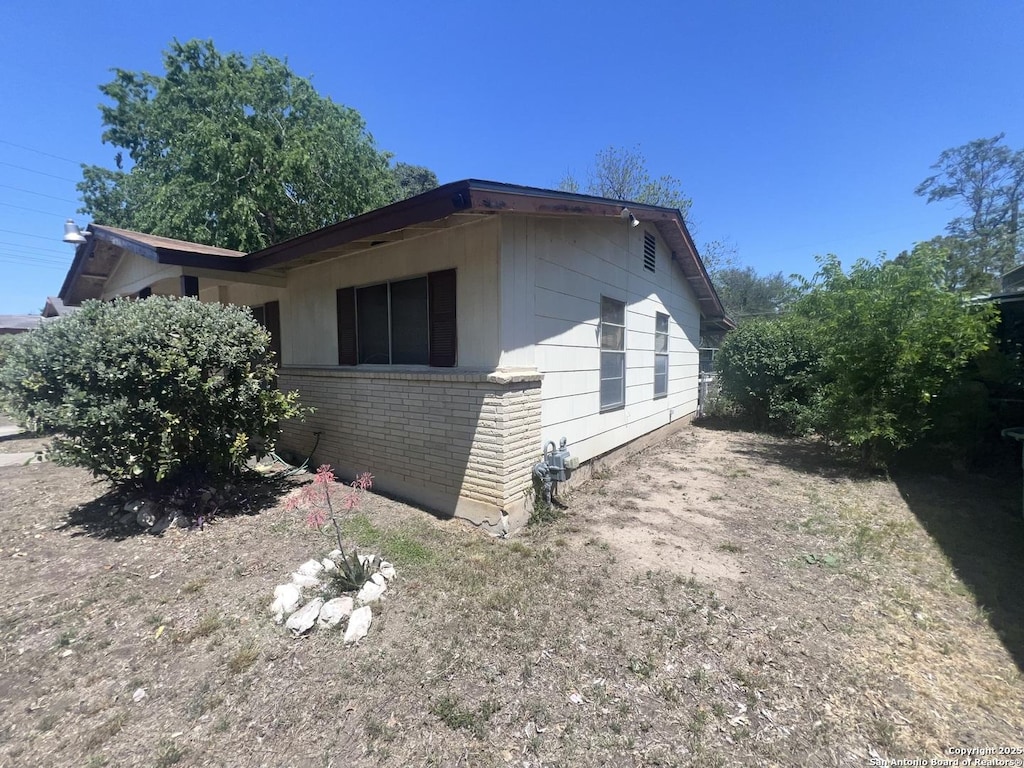 view of property exterior with brick siding