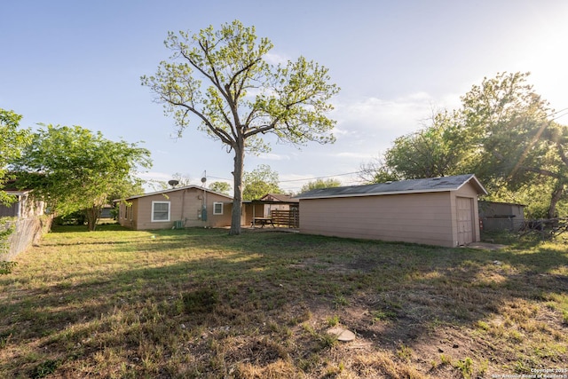 view of yard with fence and an outbuilding
