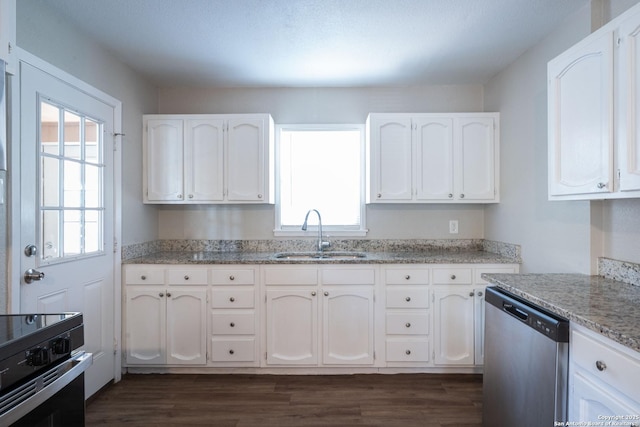 kitchen with black electric range, dark wood-style floors, stainless steel dishwasher, and a sink