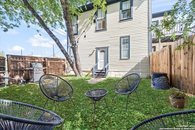 exterior space featuring entry steps and a fenced backyard